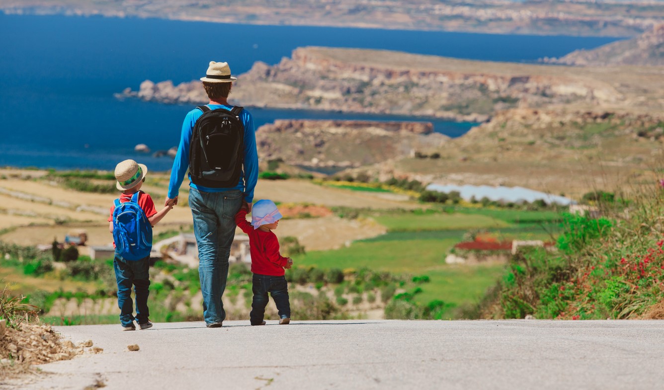 Family with two kids enjoying scenic walk in Malta
